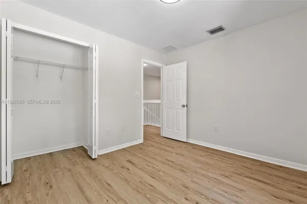 an empty room with wooden floor