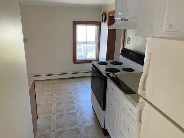 a kitchen with a stove and a refrigerator