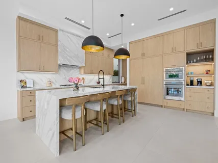 a kitchen with a sink cabinets and window