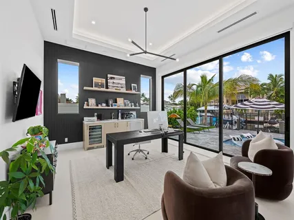 a living room with furniture a chandelier and a flat screen tv