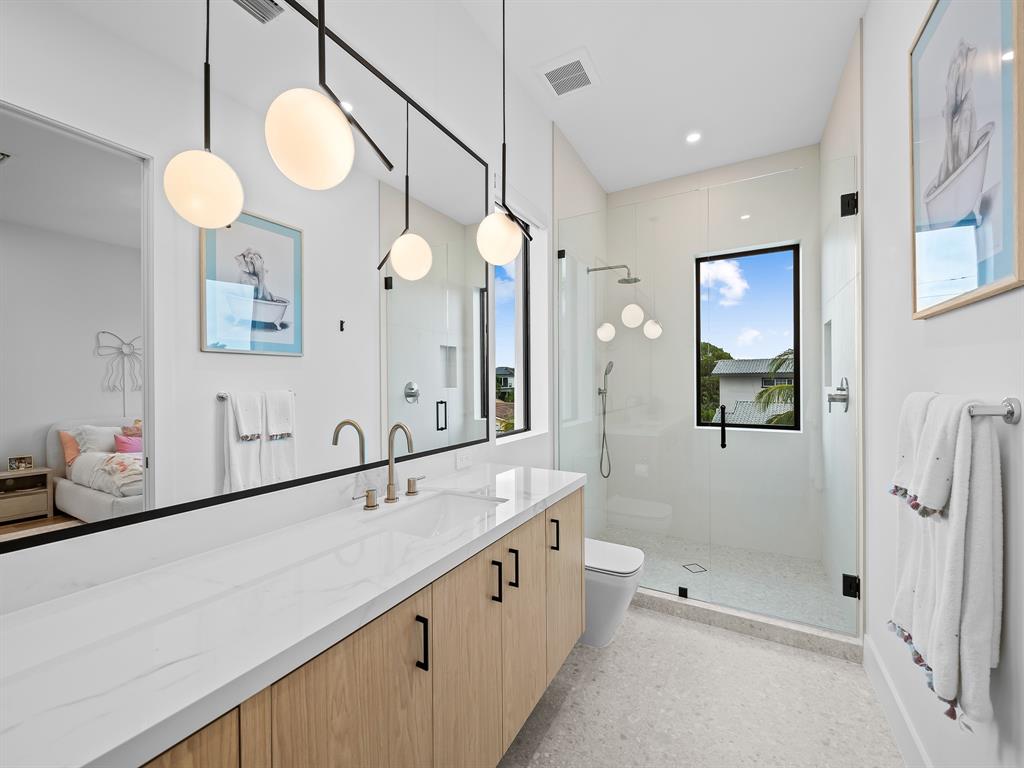 2420 Northeast 48th Street Lighthouse Point, FL 33064 - Photo 26 of 51 a spacious bathroom with a double vanity sink mirror and shower