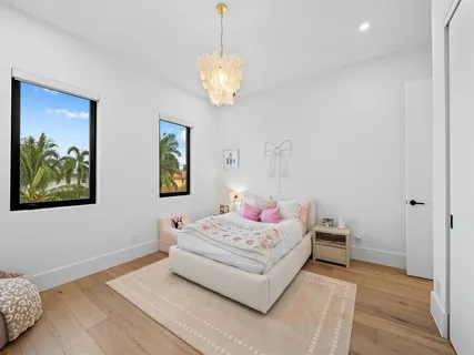 a bedroom with a bed and a chandelier