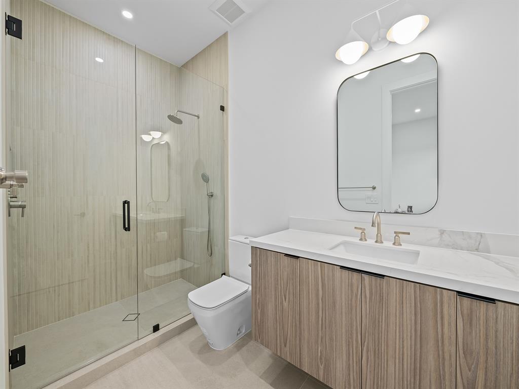 2420 Northeast 48th Street Lighthouse Point, FL 33064 - Photo 30 of 51 a bathroom with a sink a toilet and shower