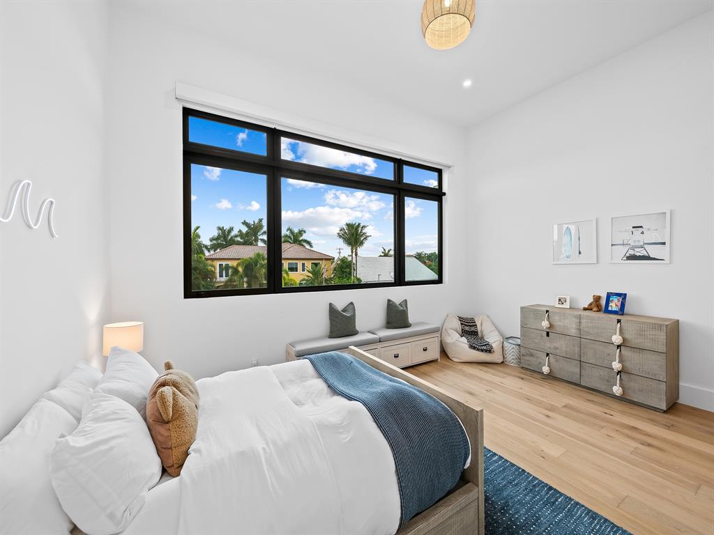 2420 Northeast 48th Street Lighthouse Point, FL 33064 - Photo 31 of 51 a bedroom with a bed and window