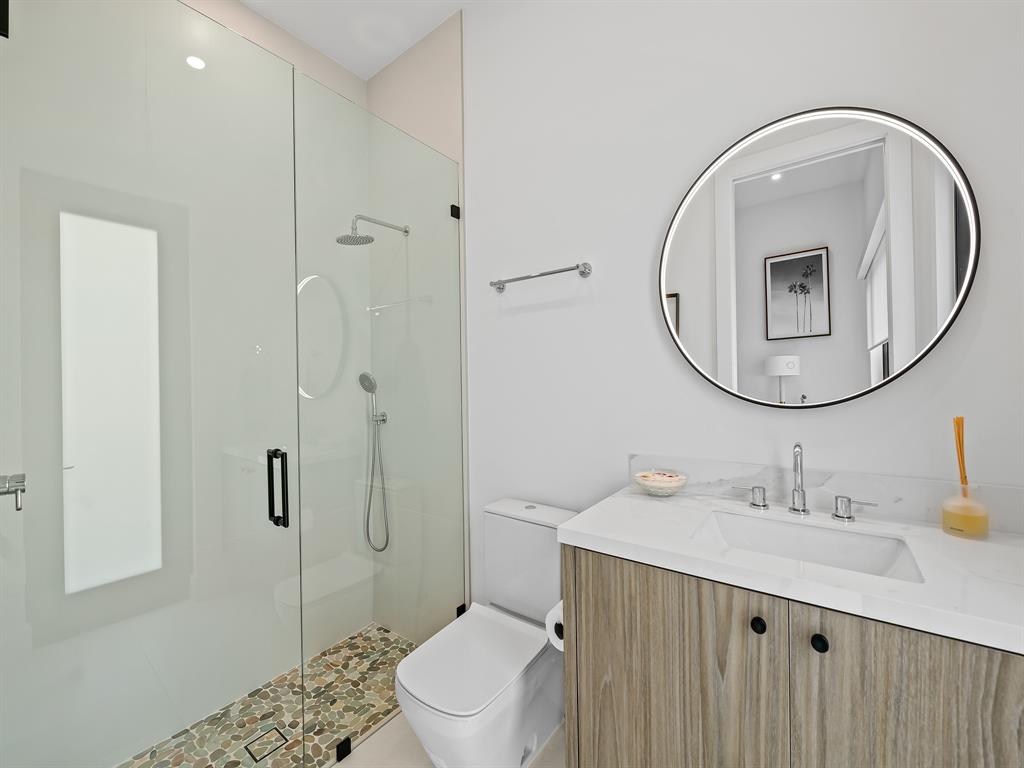 2420 Northeast 48th Street Lighthouse Point, FL 33064 - Photo 35 of 51 a bathroom with a sink a toilet and shower