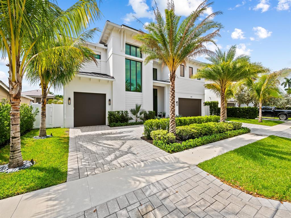 2420 Northeast 48th Street Lighthouse Point, FL 33064 - Photo 48 of 51 a front view of a house with a yard and palm trees