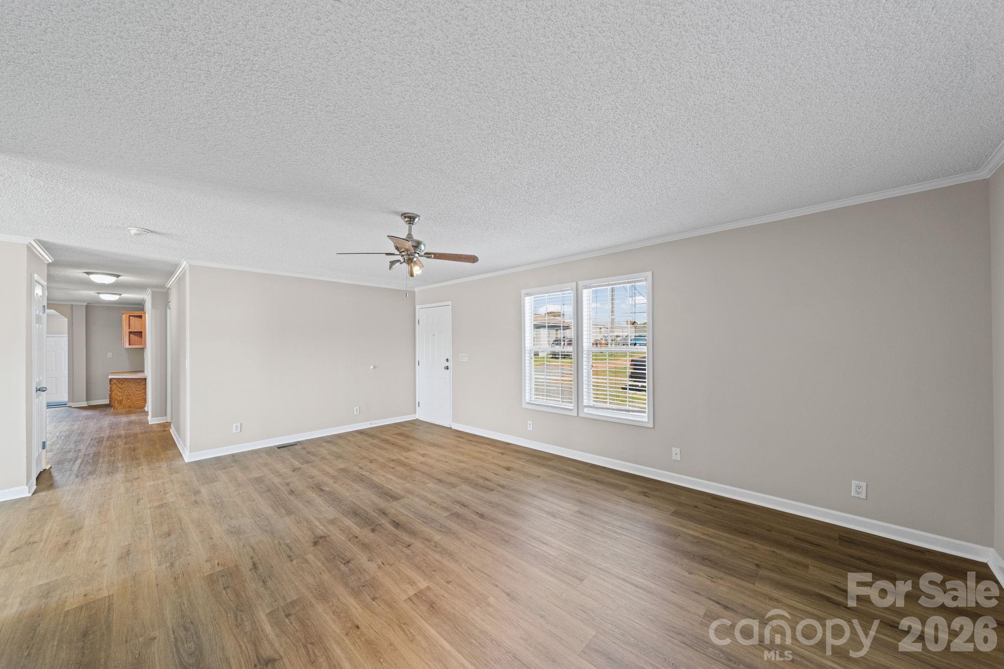 3010 Old Monroe Marshville Road Wingate, NC 28174 - Photo 11 of 44 wooden floor in an empty room with a window