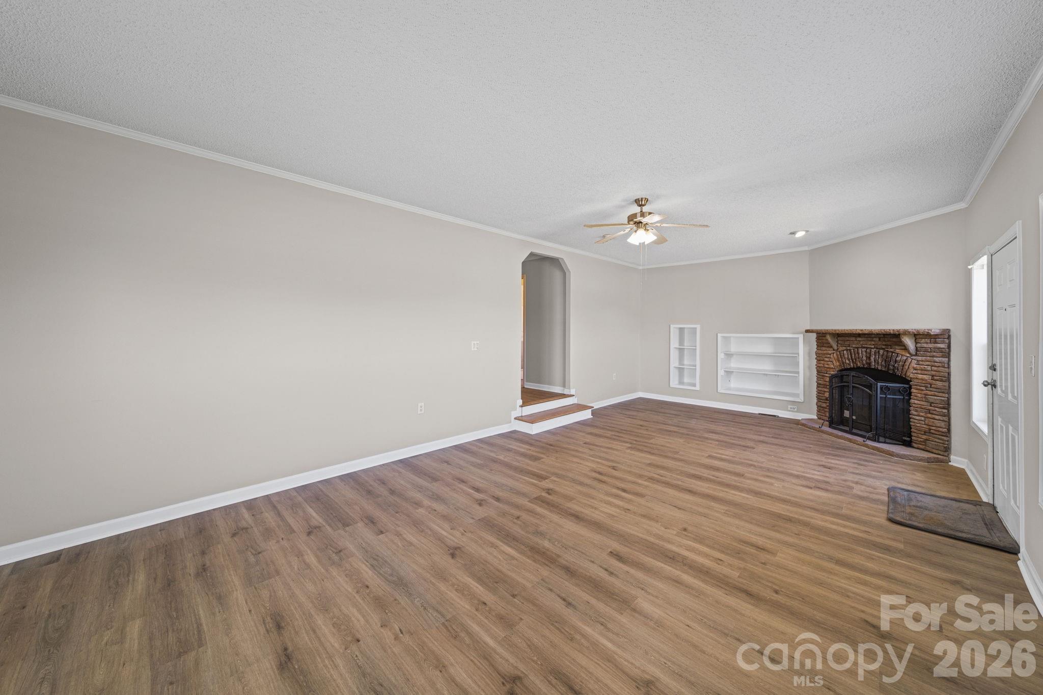 3010 Old Monroe Marshville Road Wingate, NC 28174 - Photo 14 of 44 a view of empty room with wooden floor and fireplace