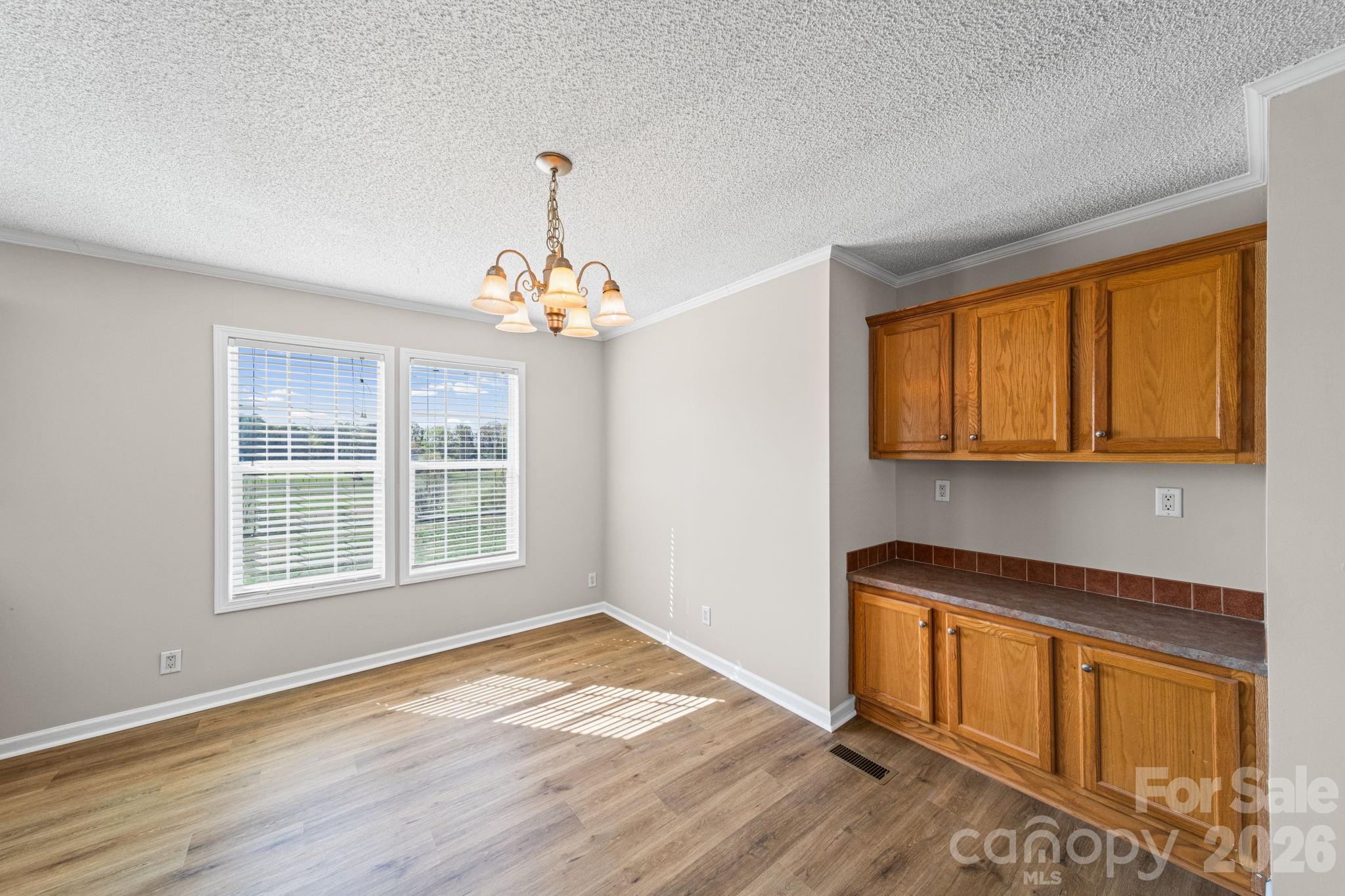 3010 Old Monroe Marshville Road Wingate, NC 28174 - Photo 15 of 44 an empty room with wooden floor and windows