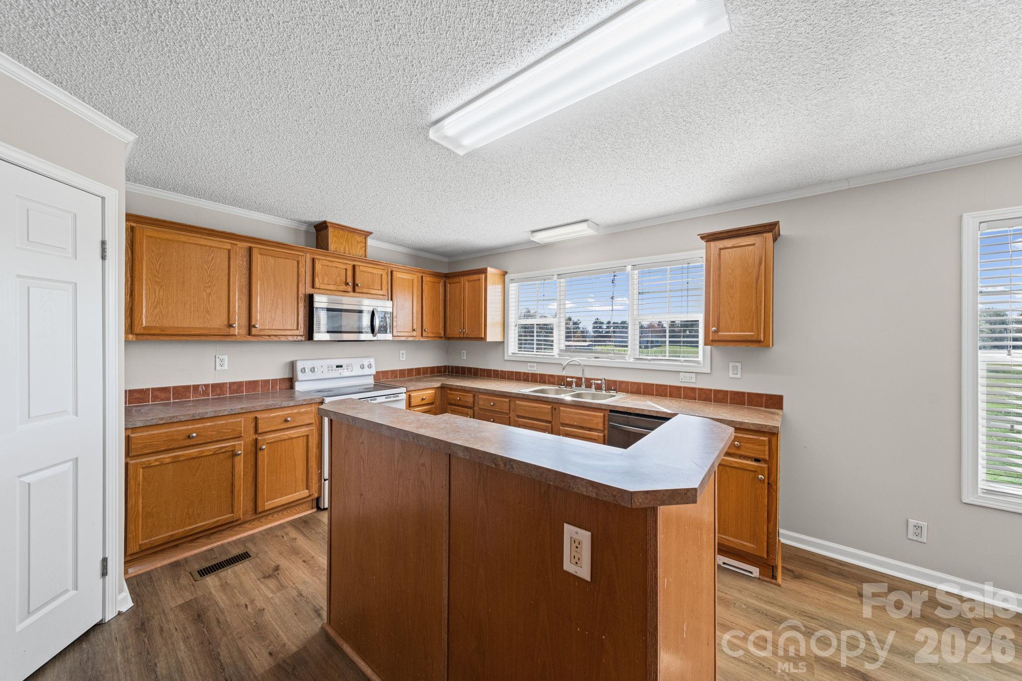 3010 Old Monroe Marshville Road Wingate, NC 28174 - Photo 19 of 44 a kitchen with stainless steel appliances granite countertop a sink stove and refrigerator