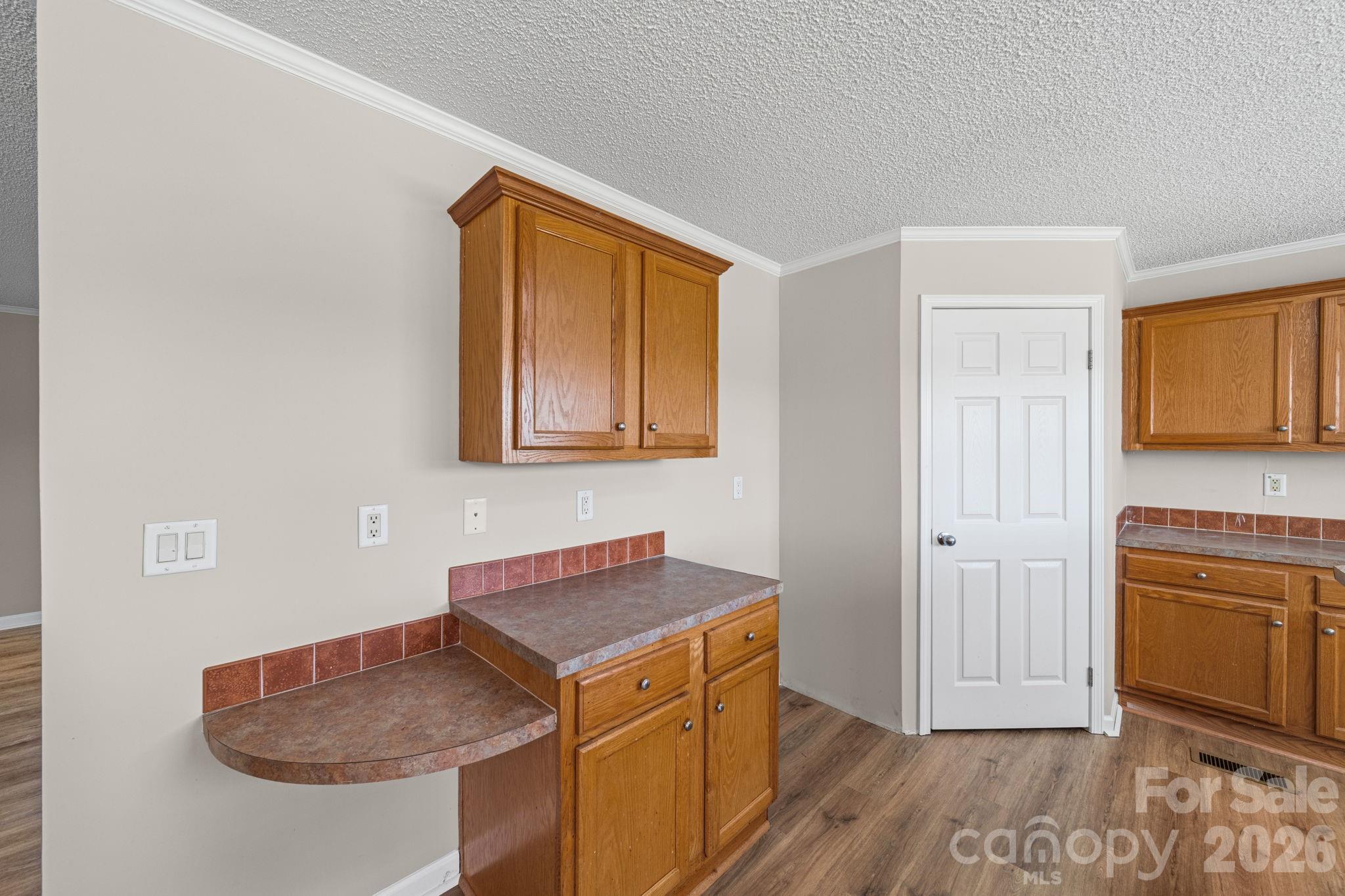 3010 Old Monroe Marshville Road Wingate, NC 28174 - Photo 20 of 44 a kitchen with a sink cabinets and wooden floor