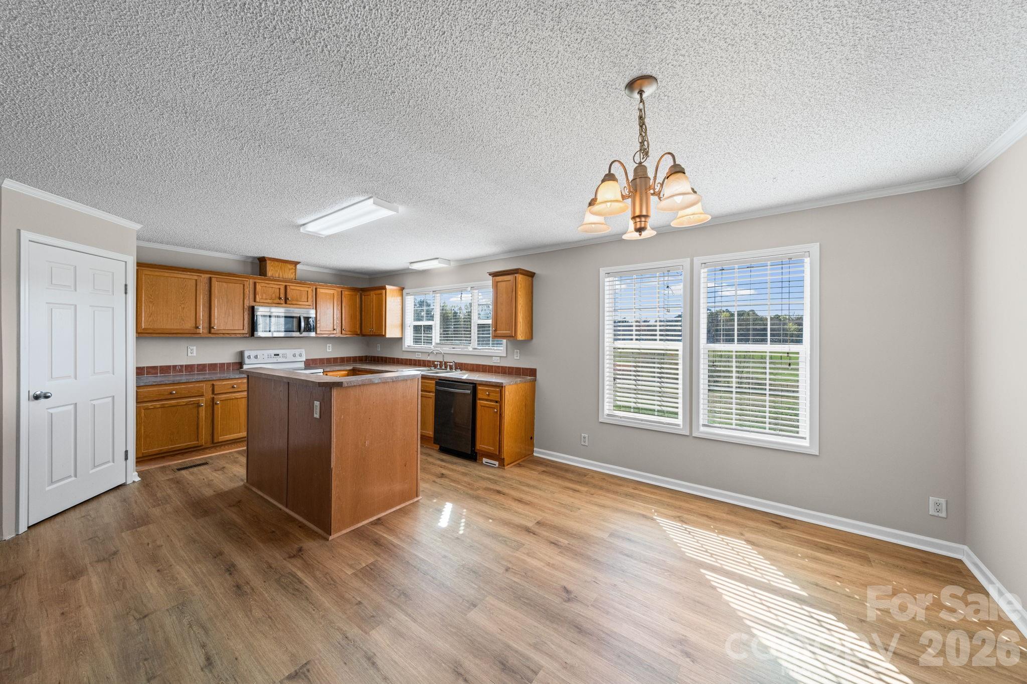 3010 Old Monroe Marshville Road Wingate, NC 28174 - Photo 23 of 44 a kitchen with stainless steel appliances granite countertop a stove a sink dishwasher and a refrigerator