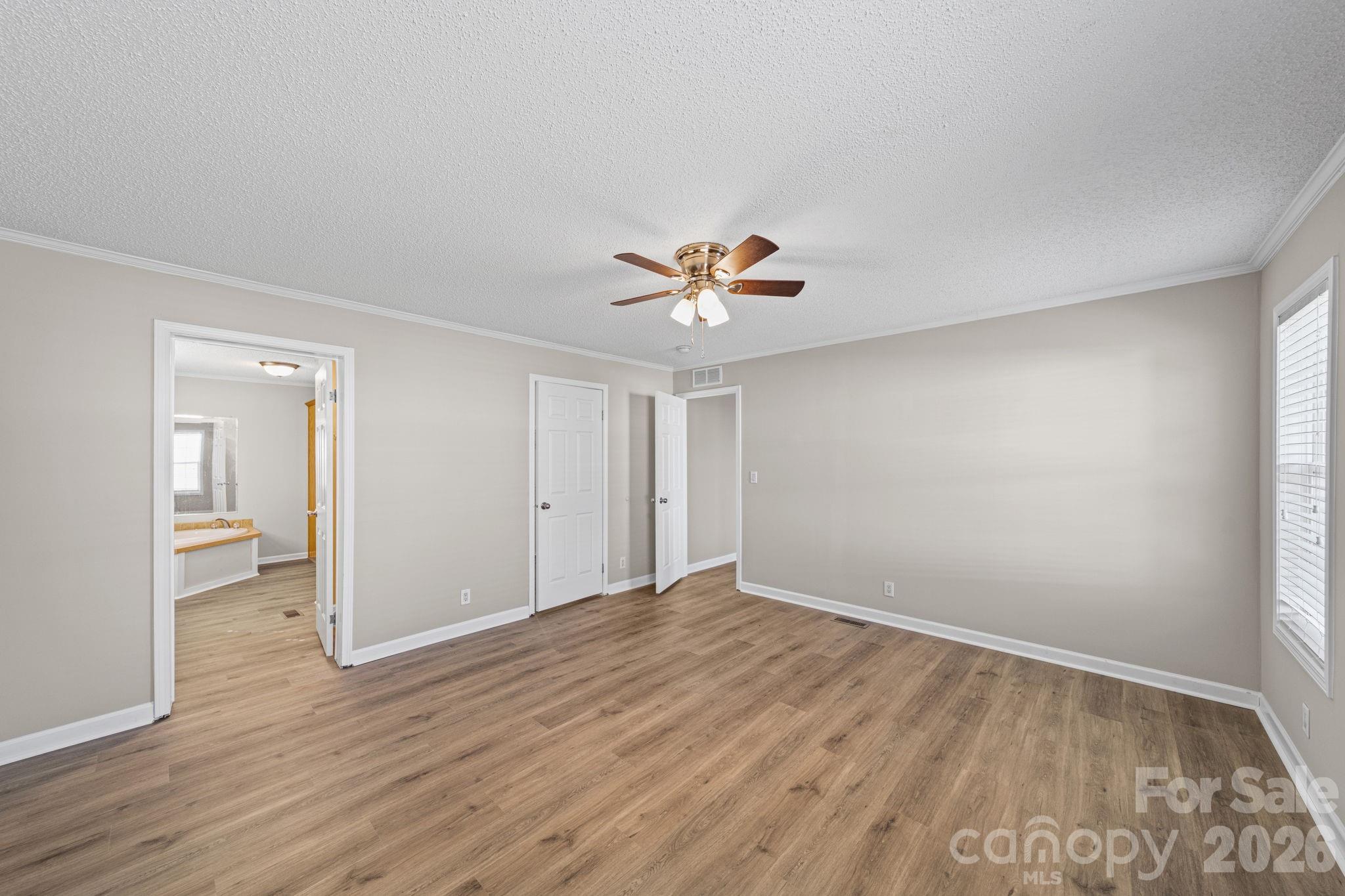 3010 Old Monroe Marshville Road Wingate, NC 28174 - Photo 26 of 44 a view of a livingroom with wooden floor and a ceiling fan