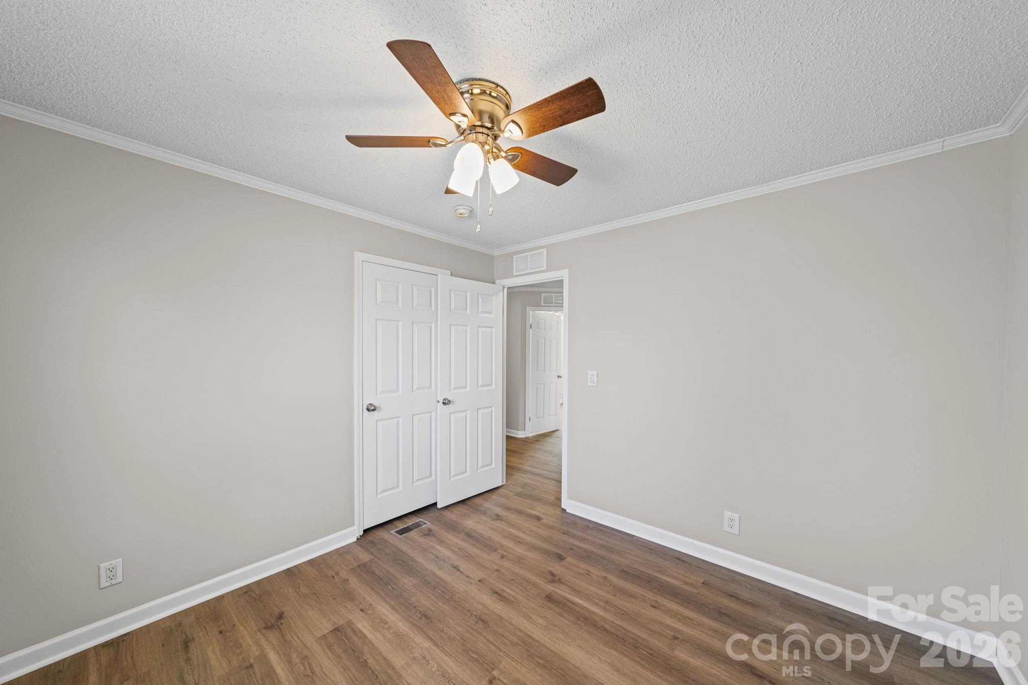 3010 Old Monroe Marshville Road Wingate, NC 28174 - Photo 27 of 44 a view of a ceiling fan with wooden floor
