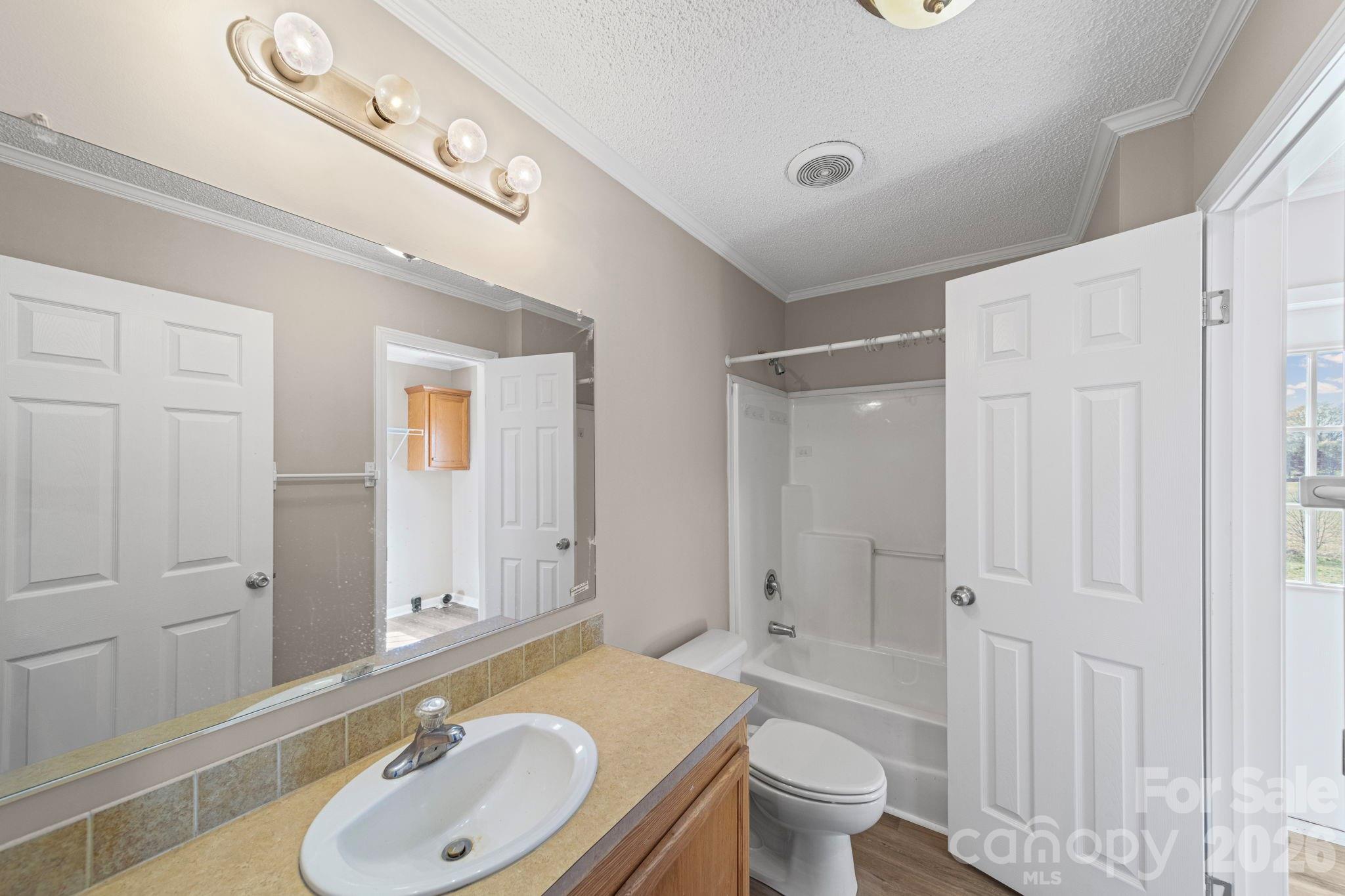 3010 Old Monroe Marshville Road Wingate, NC 28174 - Photo 32 of 44 a bathroom with a sink a toilet and shower