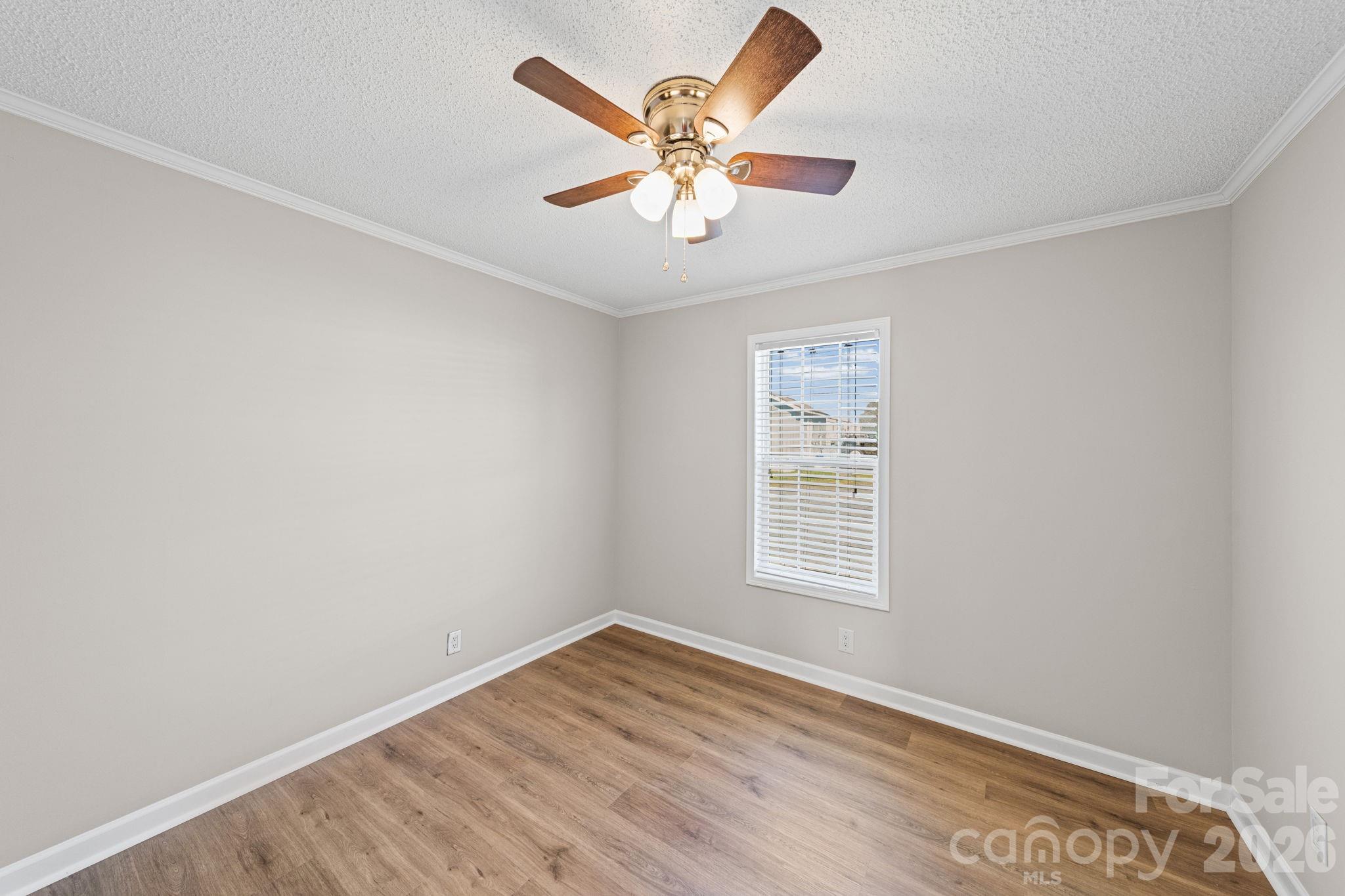 3010 Old Monroe Marshville Road Wingate, NC 28174 - Photo 34 of 44 an empty room with wooden floor and windows