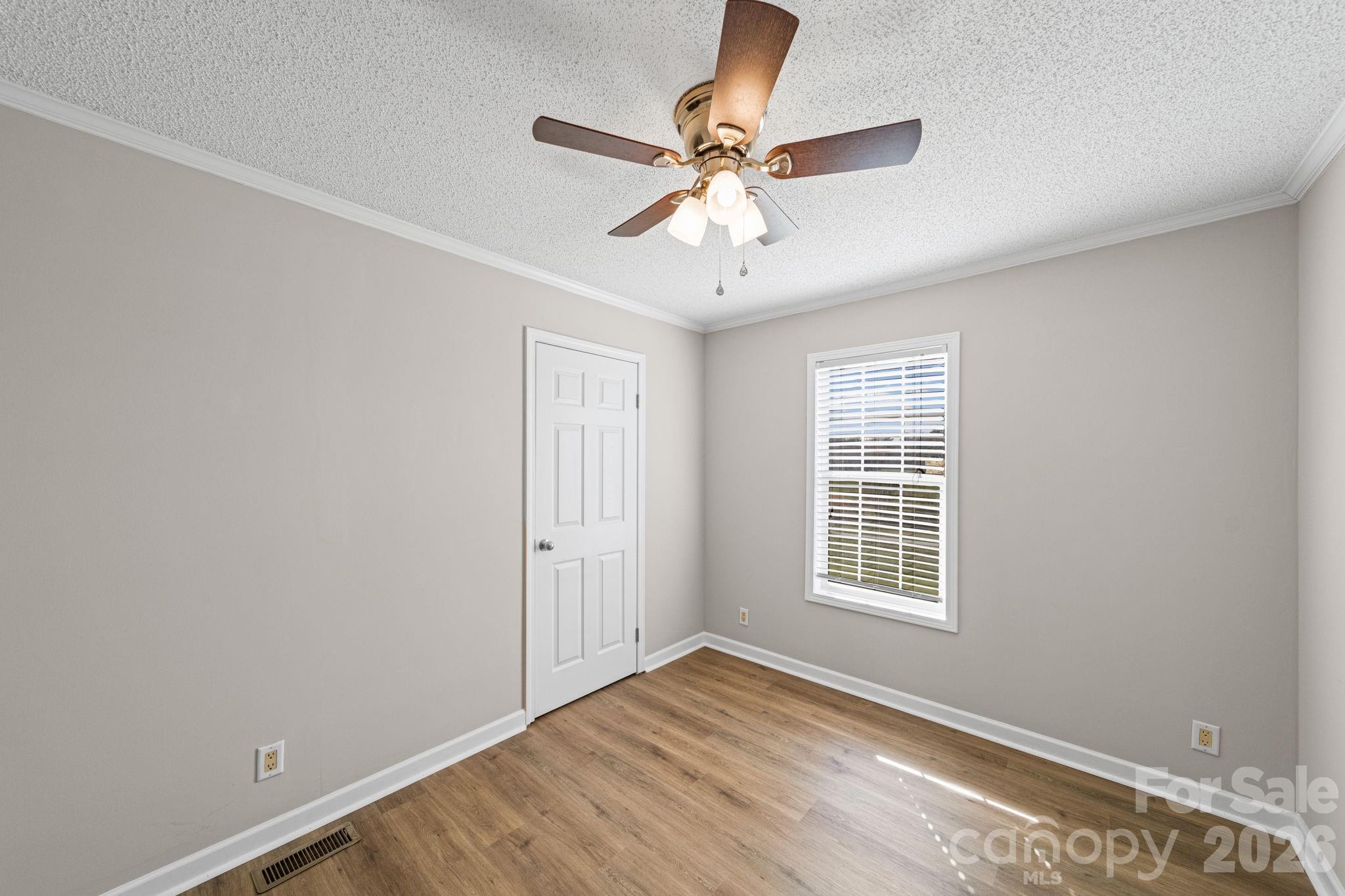 3010 Old Monroe Marshville Road Wingate, NC 28174 - Photo 35 of 44 a view of an empty room with wooden floor and a window