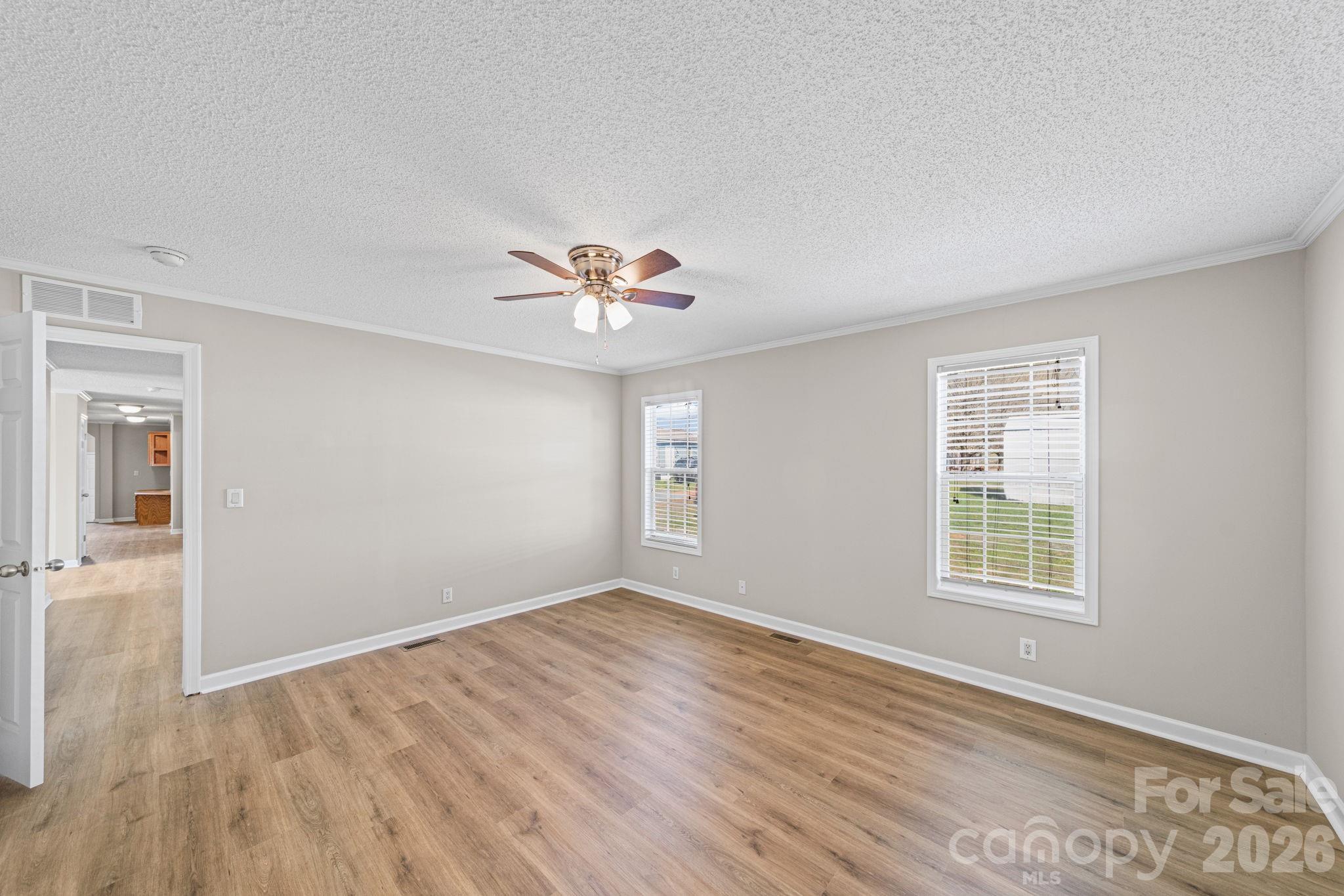 3010 Old Monroe Marshville Road Wingate, NC 28174 - Photo 36 of 44 a view of an empty room with wooden floor and a window