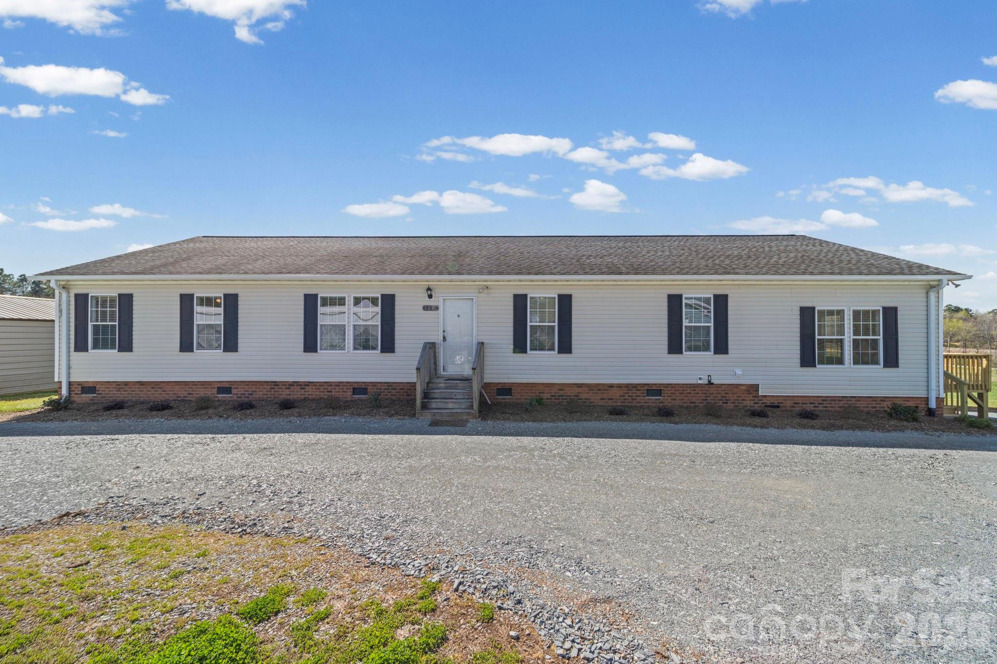3010 Old Monroe Marshville Road Wingate, NC 28174 - Photo 5 of 44 a front view of a house with a yard