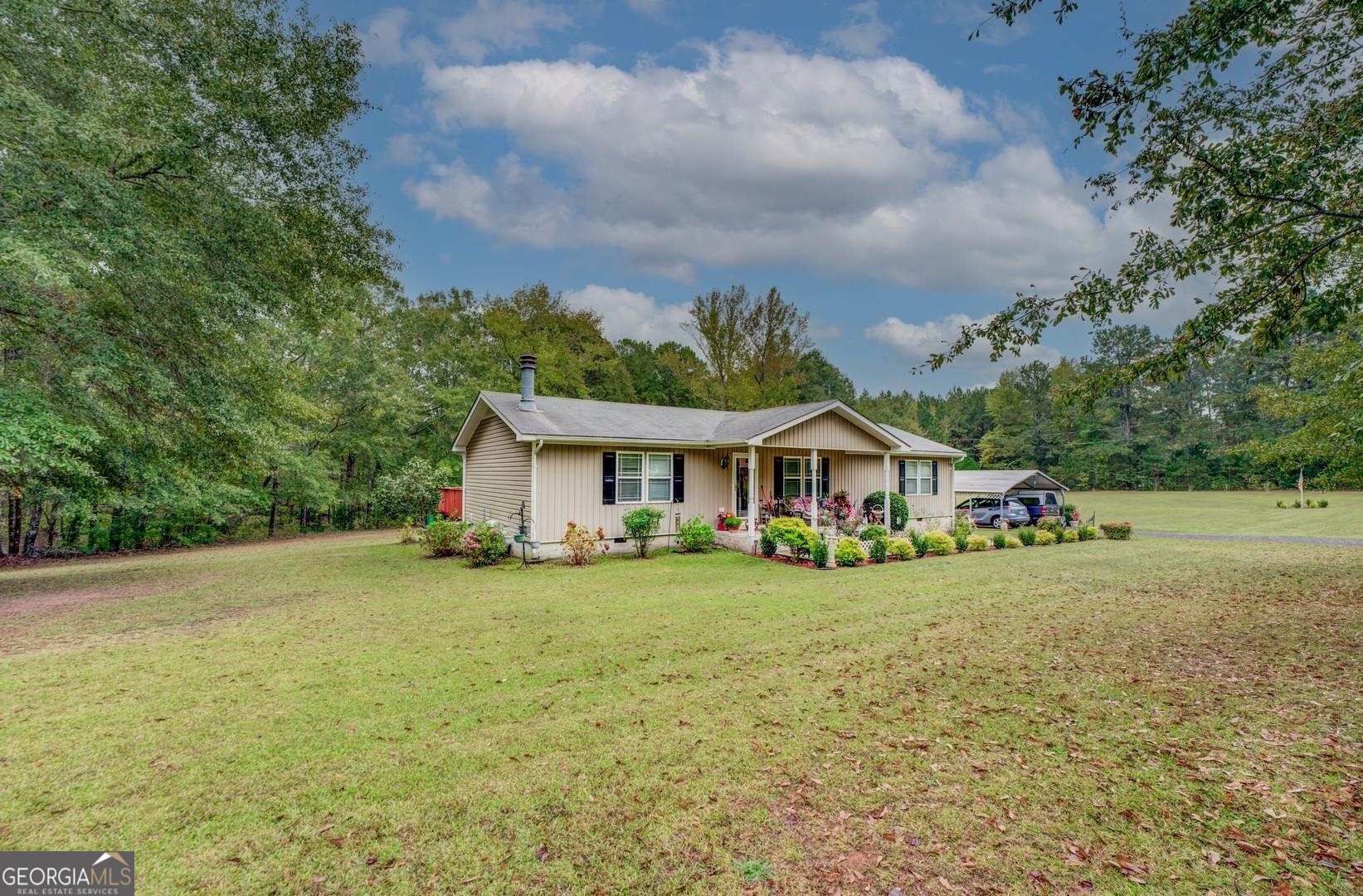 184 Biles Road Jackson, GA 30233 - Photo 1 of 1 a view of a house with a big yard and large trees
