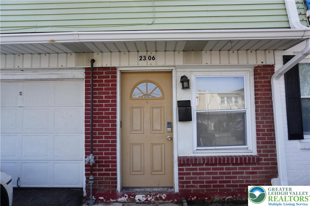 Entrance to the home with attached garage