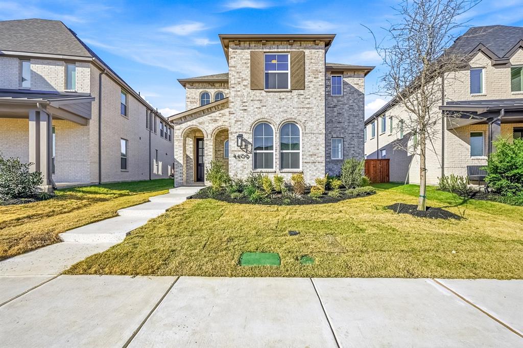 a view of a brick house with a yard