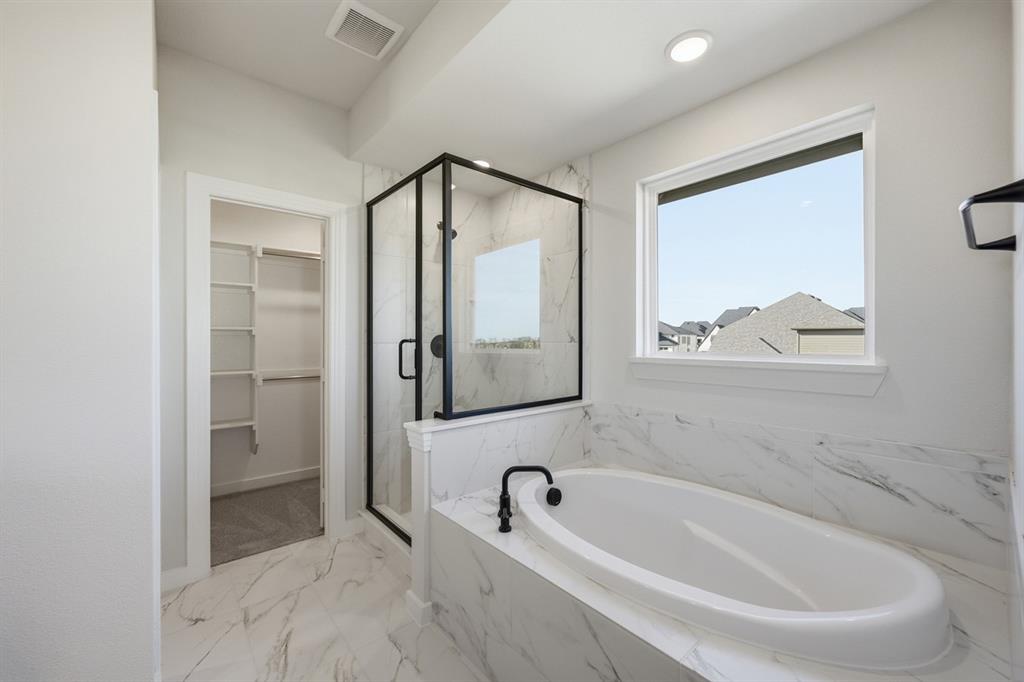 4409 Script Street Prosper, TX 75078 - Photo 13 of 24 a bathroom with bathtub and window