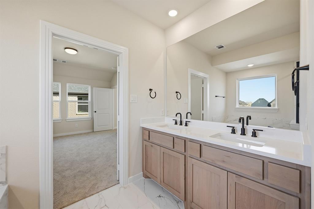 4409 Script Street Prosper, TX 75078 - Photo 14 of 24 a en suite bathroom with 2 sink flowerpot and mirror