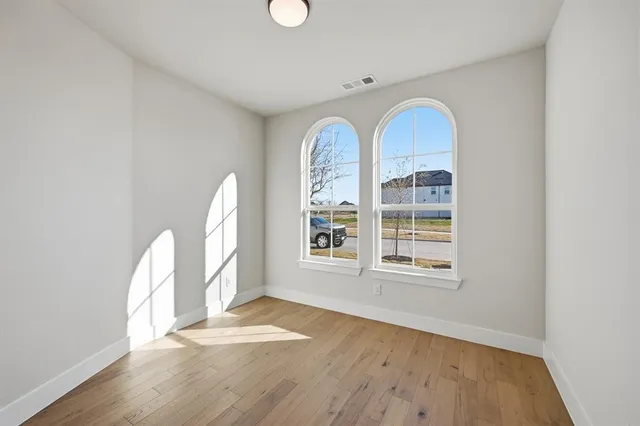 a view of a hallway with wooden floor and entryway