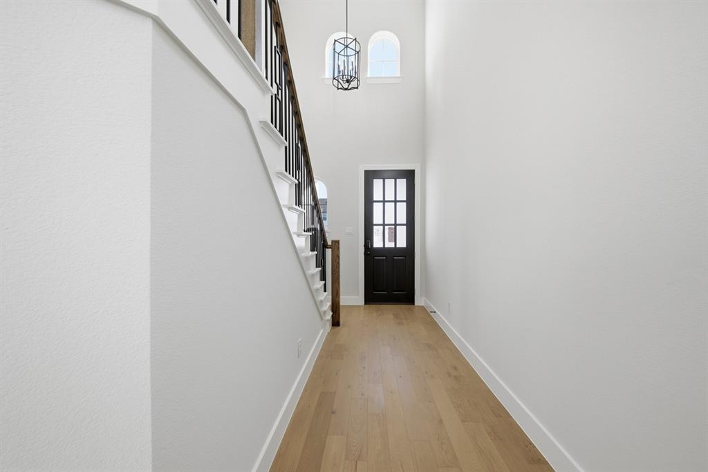 4409 Script Street Prosper, TX 75078 - Photo 19 of 24 a view of a hallway with wooden floor and entryway