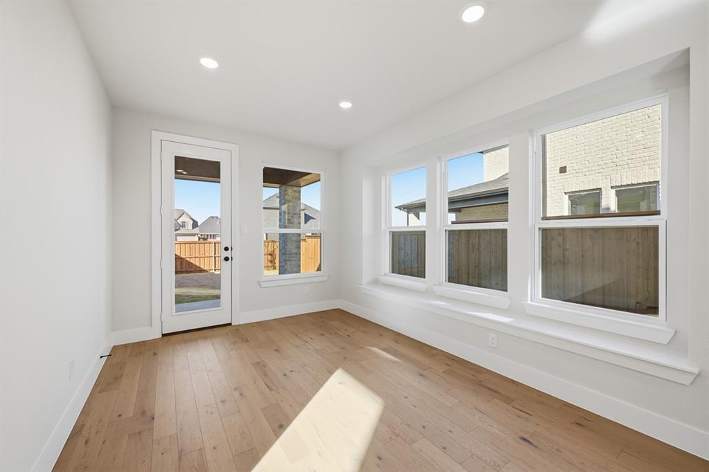 4409 Script Street Prosper, TX 75078 - Photo 20 of 24 a view of an empty room with a window and wooden floor
