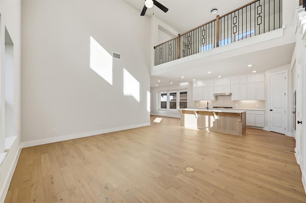 4409 Script Street Prosper, TX 75078 - Photo 10 of 24 a view of an empty room with kitchen view