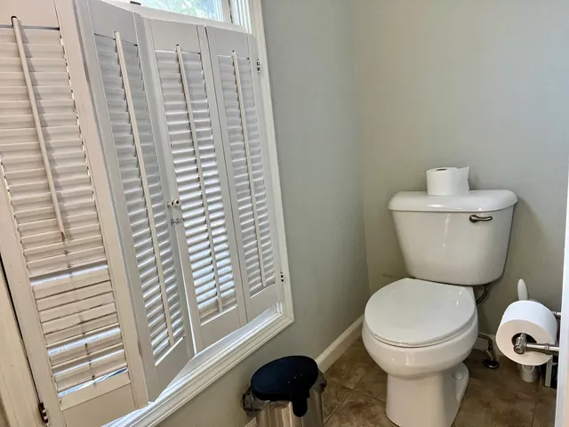 a close up of a toilet and a shower