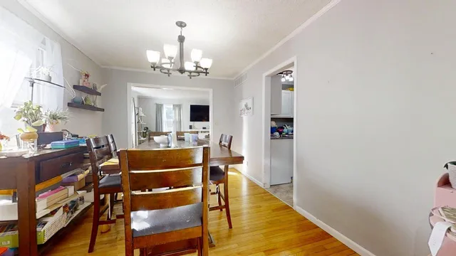 a view of a dining room with furniture and a chandelier