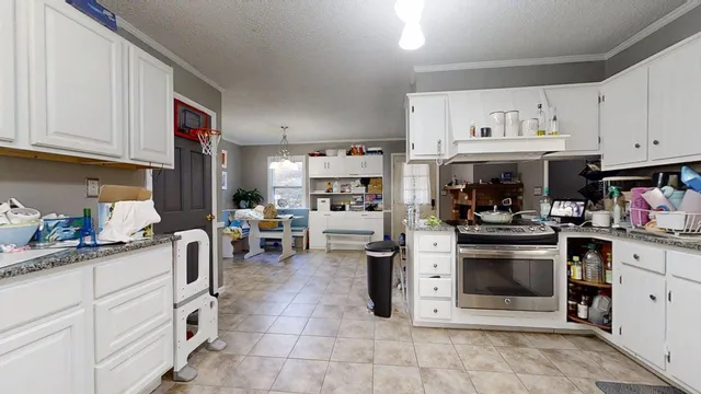 a kitchen filled with white cabinets and appliances