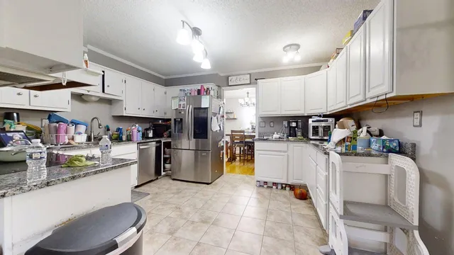 a kitchen with refrigerator and cabinets