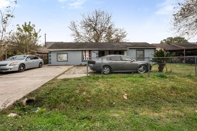 a front view of a house with a garden and plants