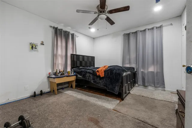 a spacious bedroom with a bed and a chandelier