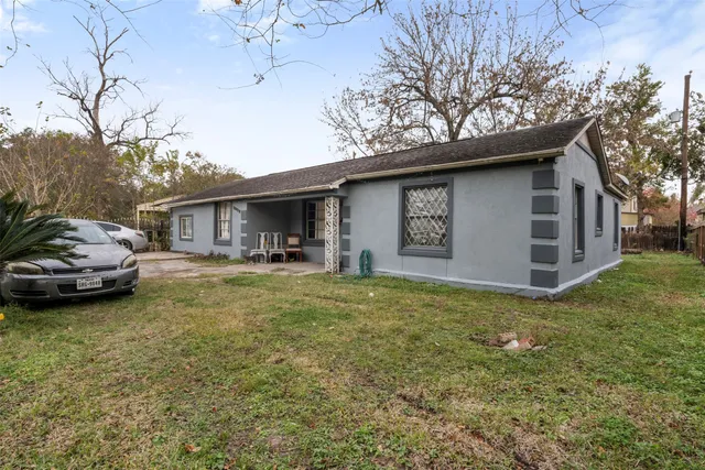 a front view of a house with a garden and yard