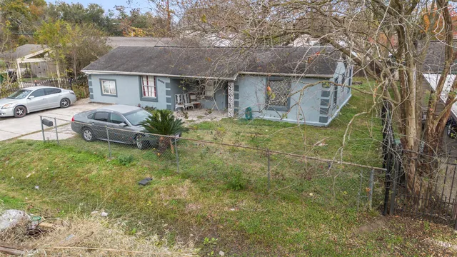 a backyard of a house with table and chairs