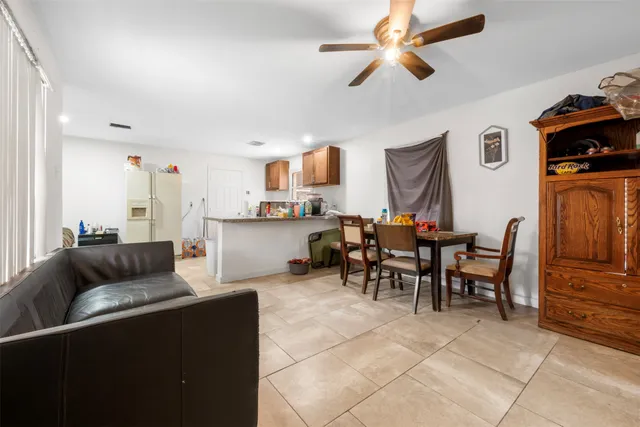 a living room with furniture and a dining table