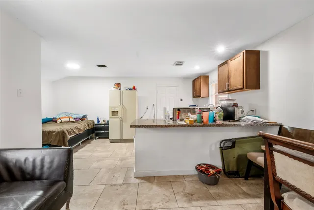 a living room with furniture and a lamp