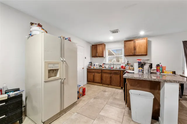a kitchen with a sink appliances and cabinets