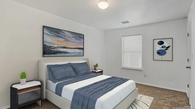 a bedroom with a bed and a painting on the wall