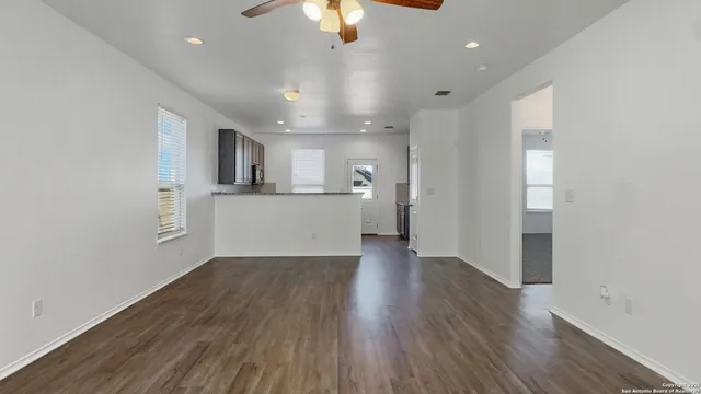 a view of a kitchen with a sink and wooden floor