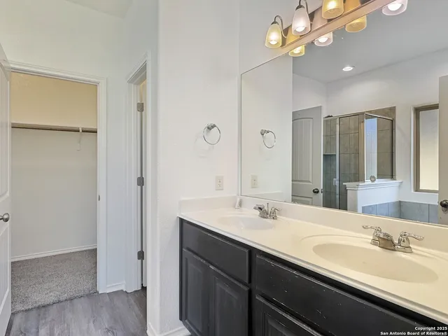 a bathroom with a sink a light fixture and a mirror