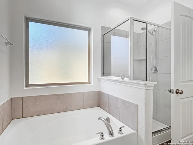 a white bath tub sitting next to a window