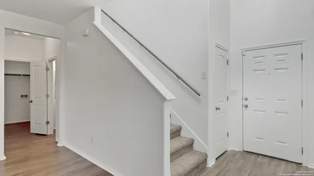 a view of entryway with stairs and wooden floor