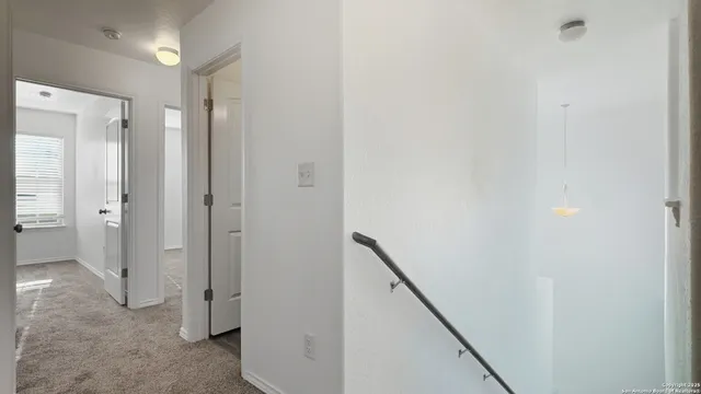 a view of a hallway with closet and wooden floor