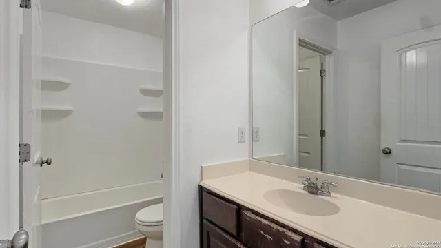 a bathroom with a sink toilet tub and shower